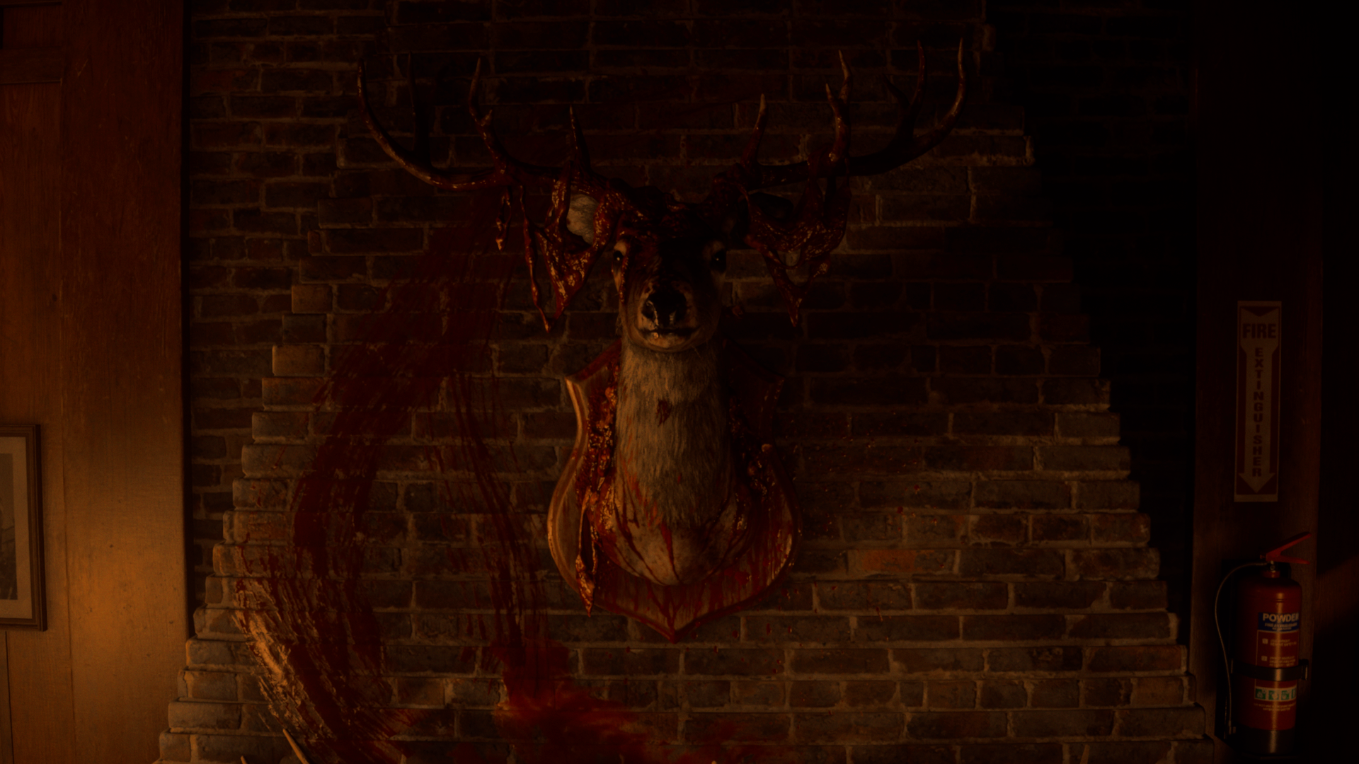 A mounted deer head with blood-splattered antlers and plaque against a brick wall, with a large, dark red smear resembling a circle nearby.